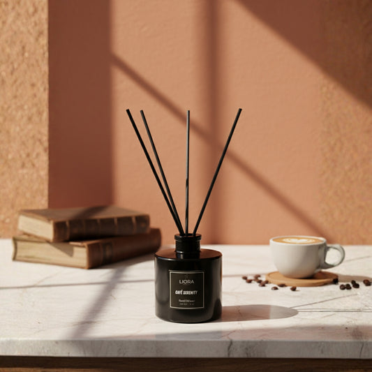 Liora Scentique Café Serenity reed diffuser in a black glass bottle with black reeds, photographed against a clean light grey studio background.
